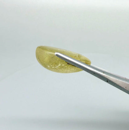 23.3 ct natural Rutilated Quartz with golden rutile inclusions, faceted cut, transparent body and visible needle patterns.