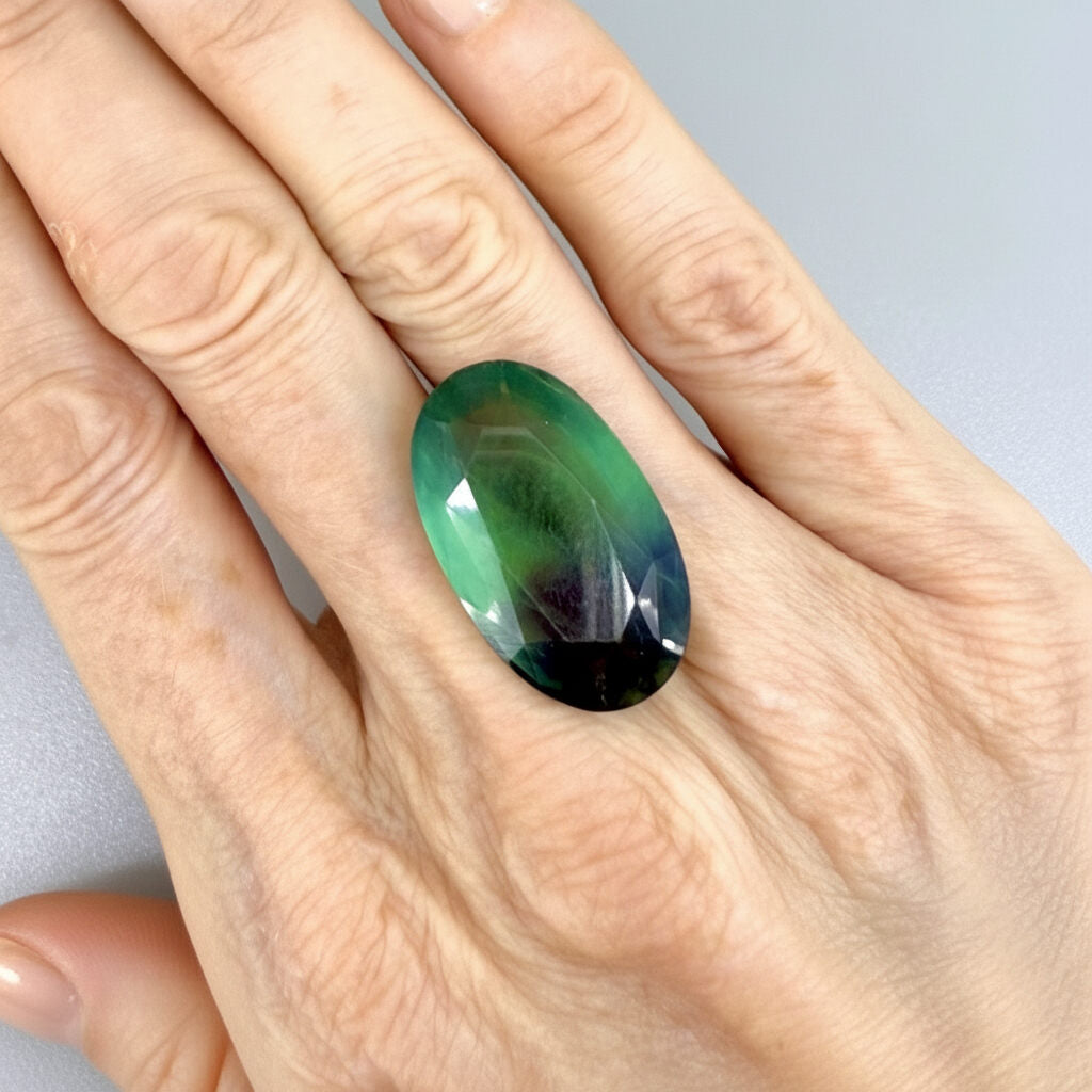 33.9 ct natural green-blue Fluorite, oval faceted, eye-clear with slight dusty or milky appearance, from Africa.