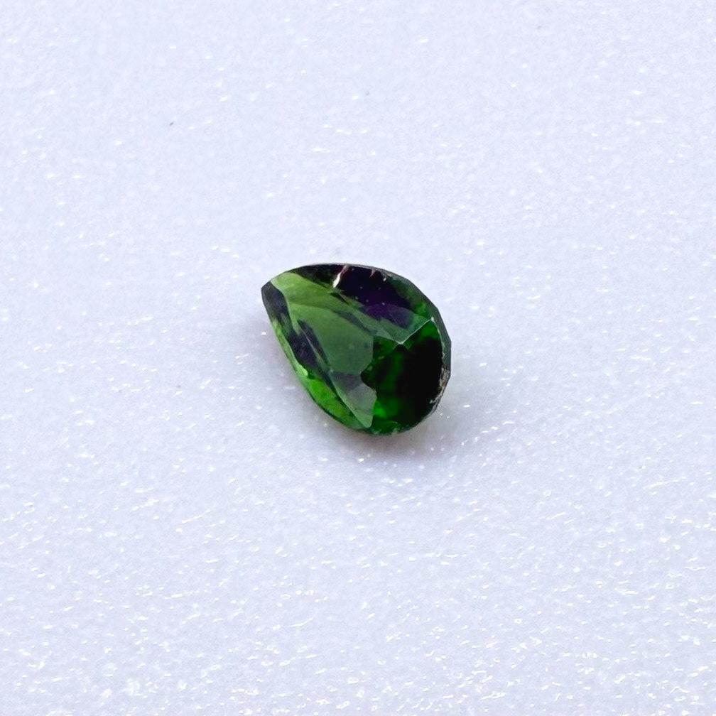 0.14 ct natural green diopside, pear cut.