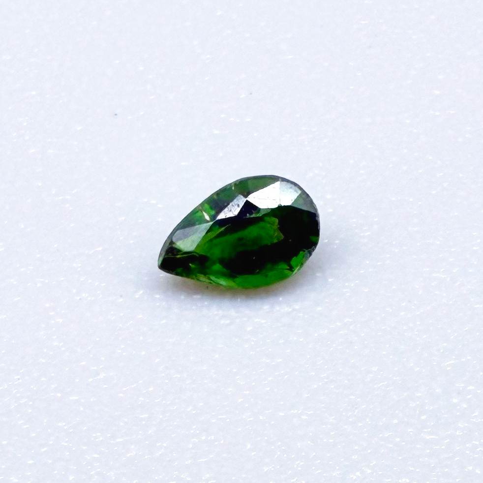 0.14 ct natural green diopside, pear cut.