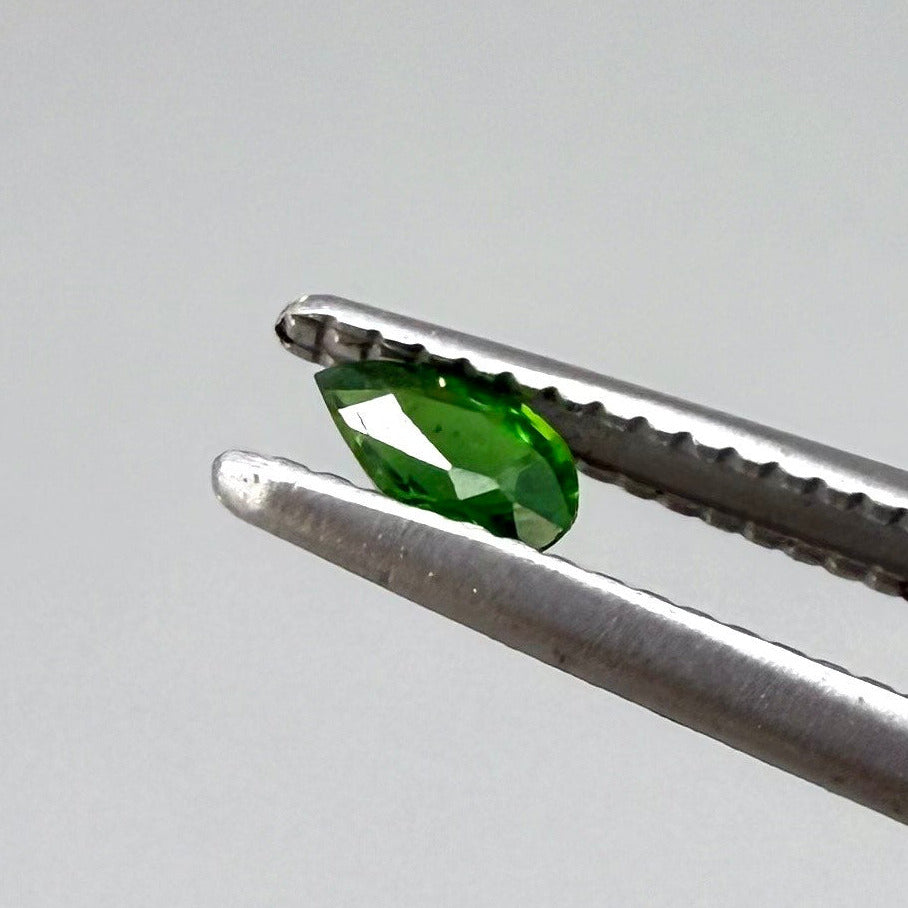 0.14 ct natural green diopside, pear cut.