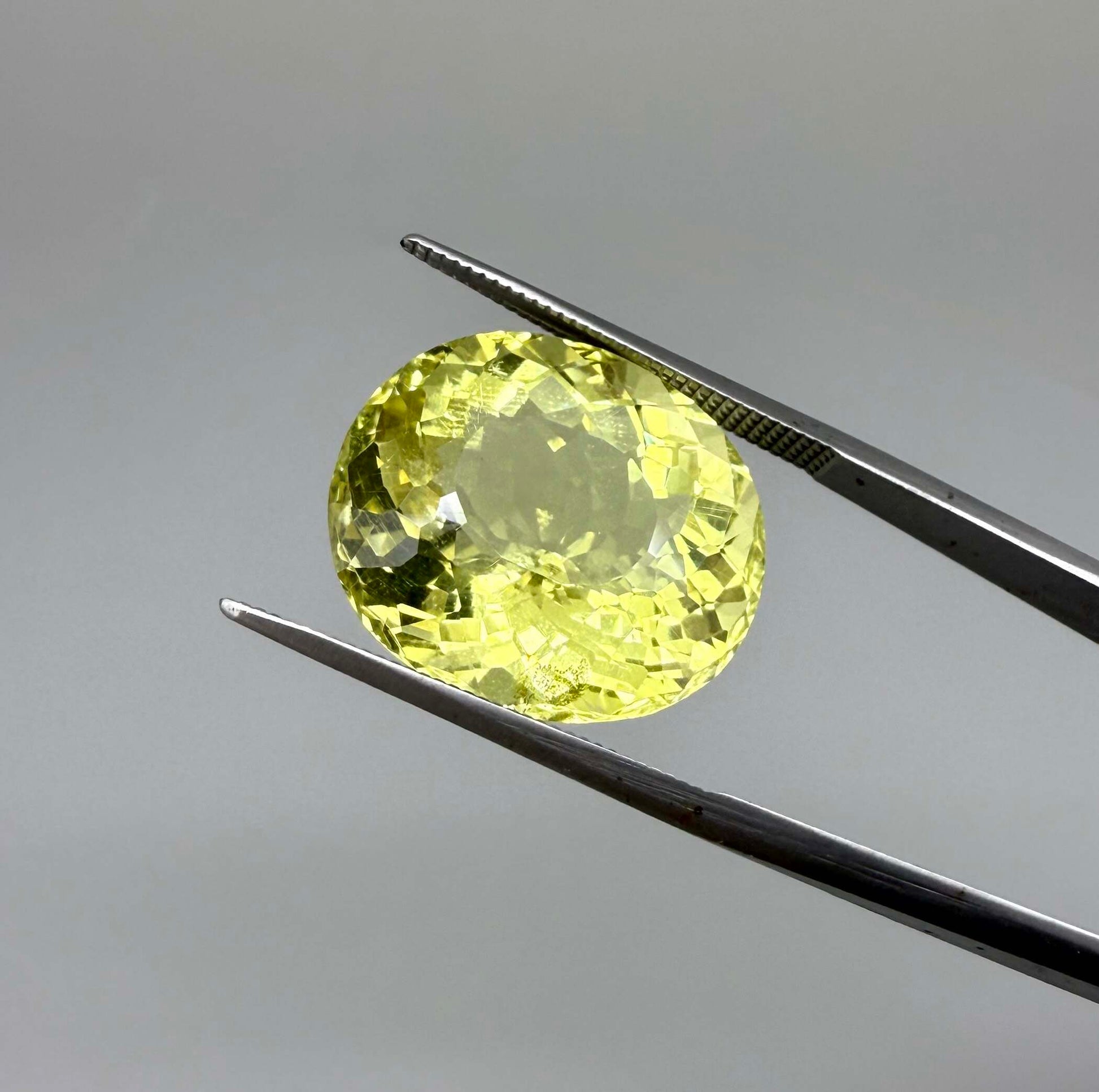 16.75 ct natural lemon quartz from Africa, oval cut with bright yellow color.