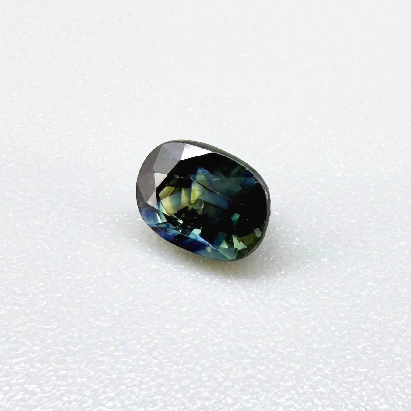 0.71 ct natural bi-color blue and yellow sapphire from Bangkaja, cushion cut.