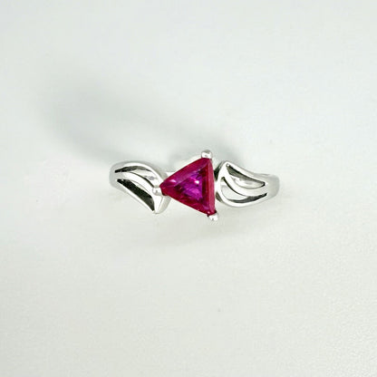 Ruby triangle-cut ring in white gold plated sterling silver, featuring a vivid red natural gemstone in a modern geometric solitaire design.