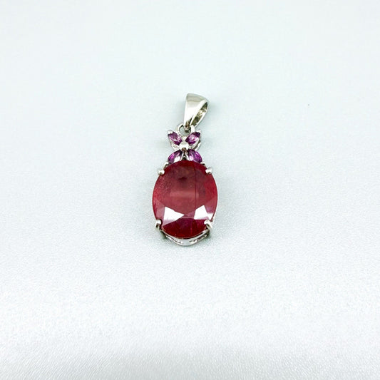 White gold plated silver pendant featuring a 7.87 ct ruby and 0.33 ct rhodolite garnets; elegant red and pink gemstone design.