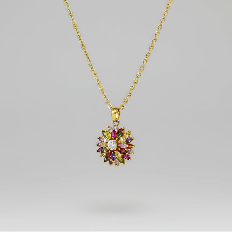 Gold-plated silver pendant with natural fancy sapphires and a central ruby in a floral arrangement.