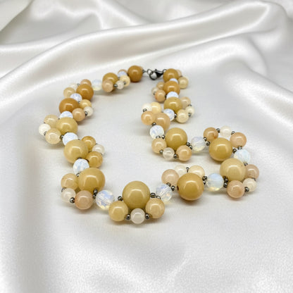 Handcrafted 41 cm necklace made from yellow jade and white opal beads in golden-yellow and ivory tones, featuring smooth round gemstones in varying sizes.