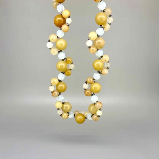 Handcrafted 41 cm necklace made from yellow jade and white opal beads in golden-yellow and ivory tones, featuring smooth round gemstones in varying sizes.
