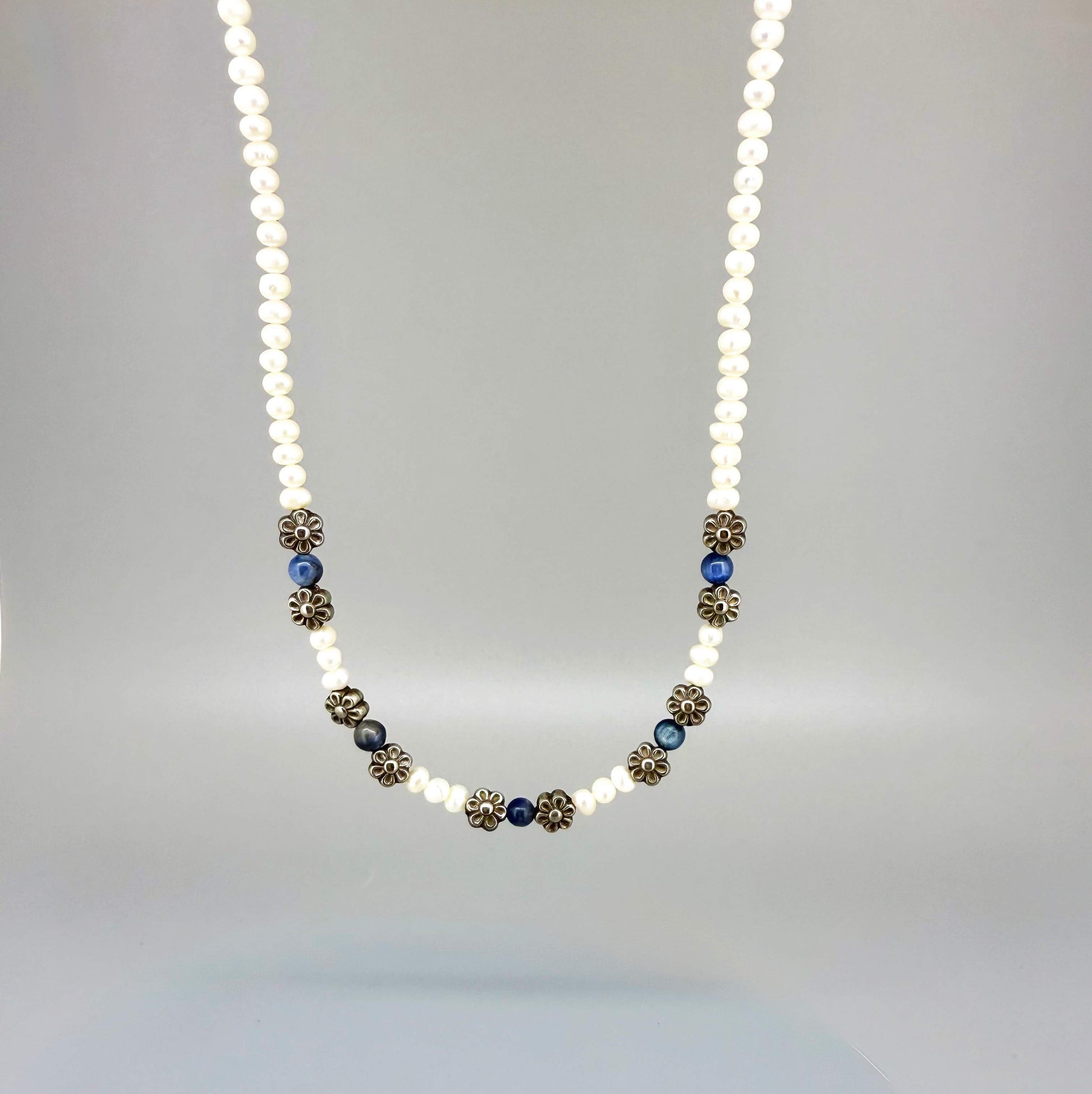 Japan pearl and sapphire necklace with floral metal spacer elements, 42 cm / 16.5 in long, featuring white pearls and deep blue stones.
