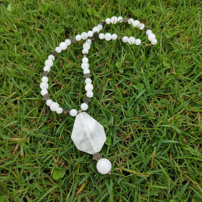 Rose quartz beaded jewelry set with golden spacers, including necklace with pendant, bracelet, and earrings in soft pink tones.