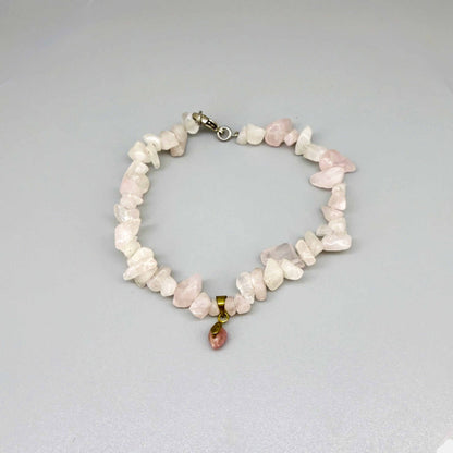 Rose quartz jewelry set with necklace, bracelet, and earrings in soft pink and gold tones, handcrafted with natural rose quartz beads.