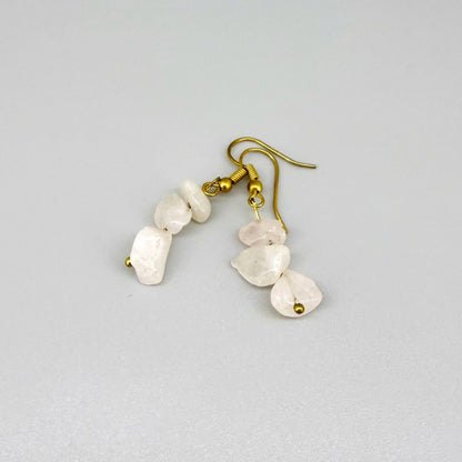 Rose quartz jewelry set with necklace, bracelet, and earrings in soft pink and gold tones, handcrafted with natural rose quartz beads.