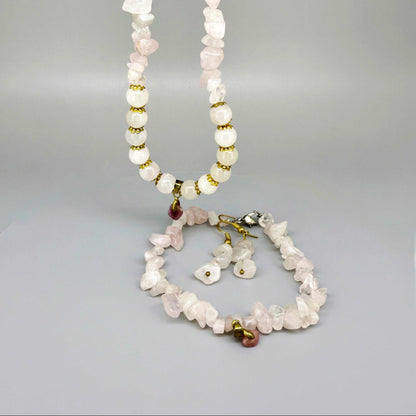 Rose quartz jewelry set with necklace, bracelet, and earrings in soft pink and gold tones, handcrafted with natural rose quartz beads.
