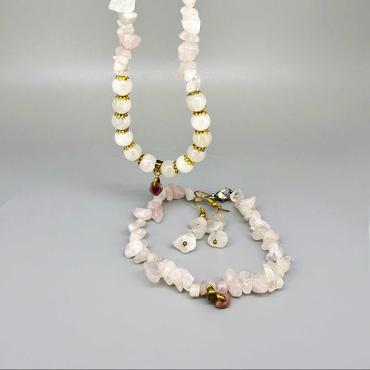 Rose quartz jewelry set with necklace, bracelet, and earrings in soft pink and gold tones, handcrafted with natural rose quartz beads.