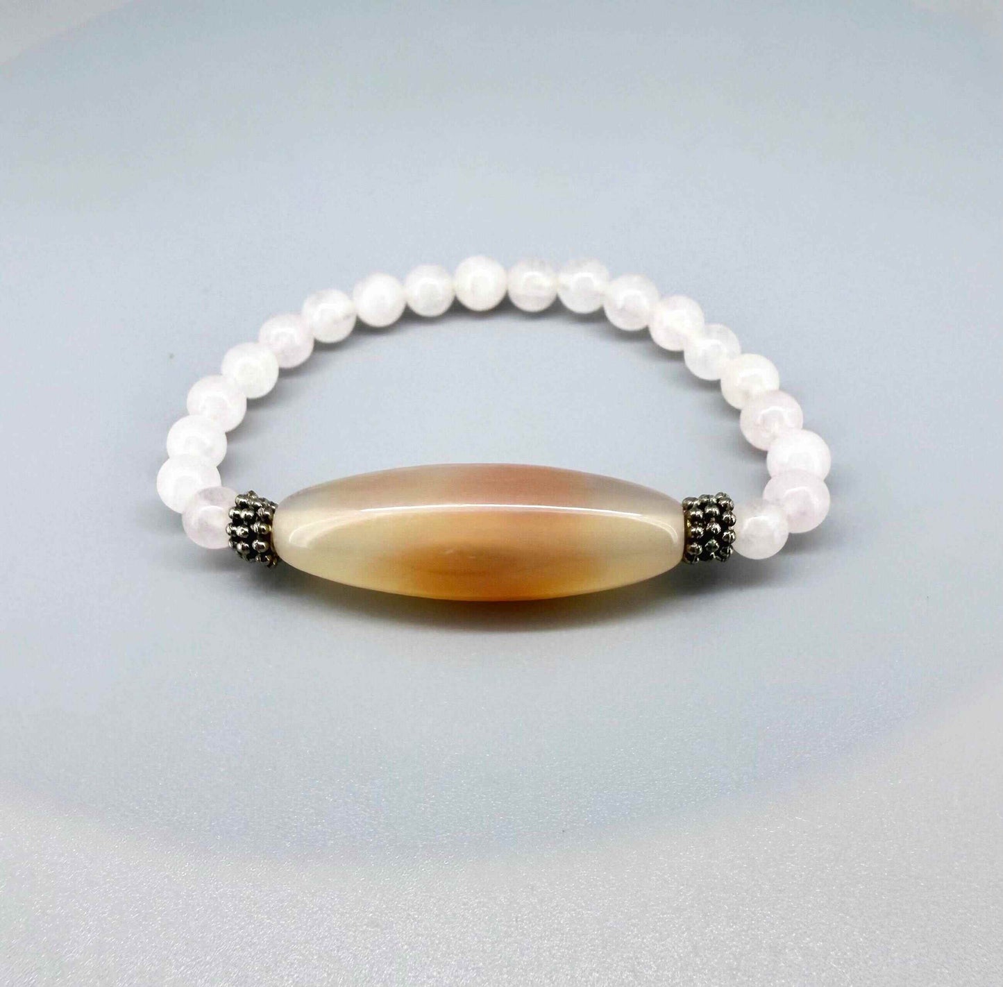 Rose quartz necklace and bracelet set, featuring soft pink beads with peach-toned accent stones, necklace 46 cm / 18.1 in, bracelet 17 cm / 6.7 in.