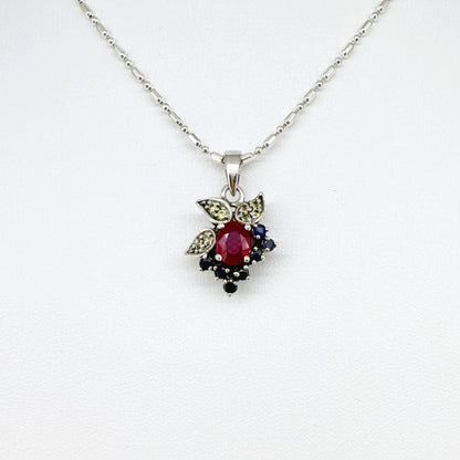 Handcrafted pendant with ruby (1.22 ct), sapphires (0.41 ct) and peridots (0.13 ct), set in white-gold-plated sterling silver.