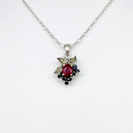 Handcrafted pendant with ruby (1.22 ct), sapphires (0.41 ct) and peridots (0.13 ct), set in white-gold-plated sterling silver.