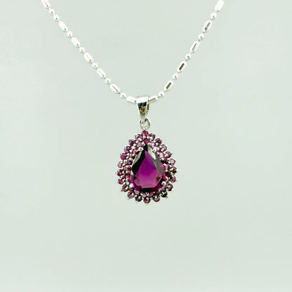 Teardrop pendant with 3.4 ct rubellite tourmaline surrounded by natural rubies, set in white-gold-plated sterling silver.