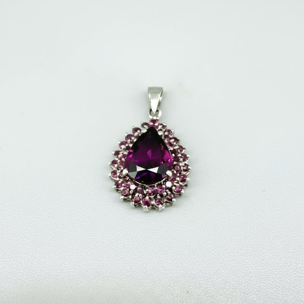 Teardrop pendant with 3.4 ct rubellite tourmaline surrounded by natural rubies, set in white-gold-plated sterling silver.
