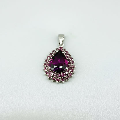 Teardrop pendant with 3.4 ct rubellite tourmaline surrounded by natural rubies, set in white-gold-plated sterling silver.