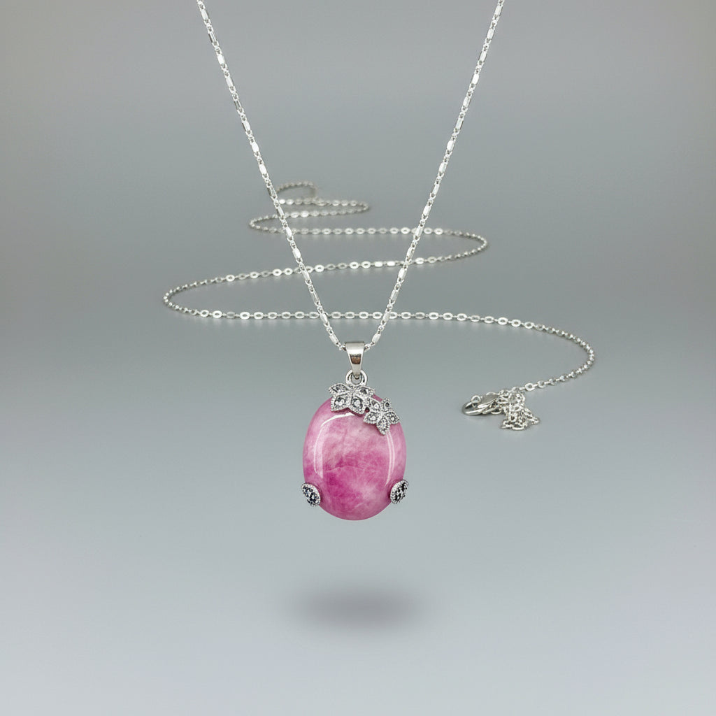 Handcrafted pendant with 46.3 ct natural ruby cabochon and 2.05 ct light blue sapphires in a white-gold-plated silver floral design.