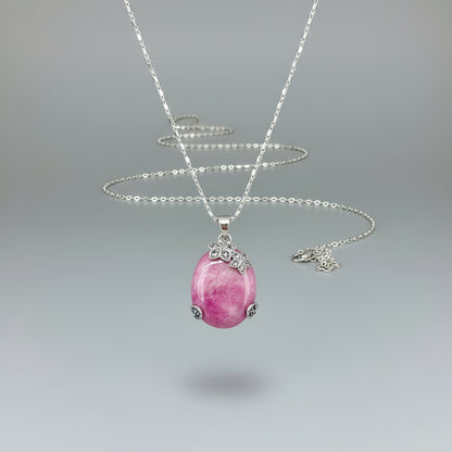 Handcrafted pendant with 46.3 ct natural ruby cabochon and 2.05 ct light blue sapphires in a white-gold-plated silver floral design.