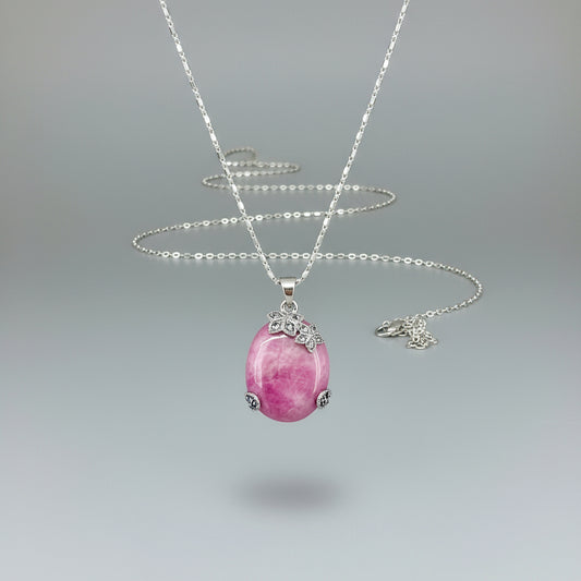 Handcrafted pendant with 46.3 ct natural ruby cabochon and 2.05 ct light blue sapphires in a white-gold-plated silver floral design.