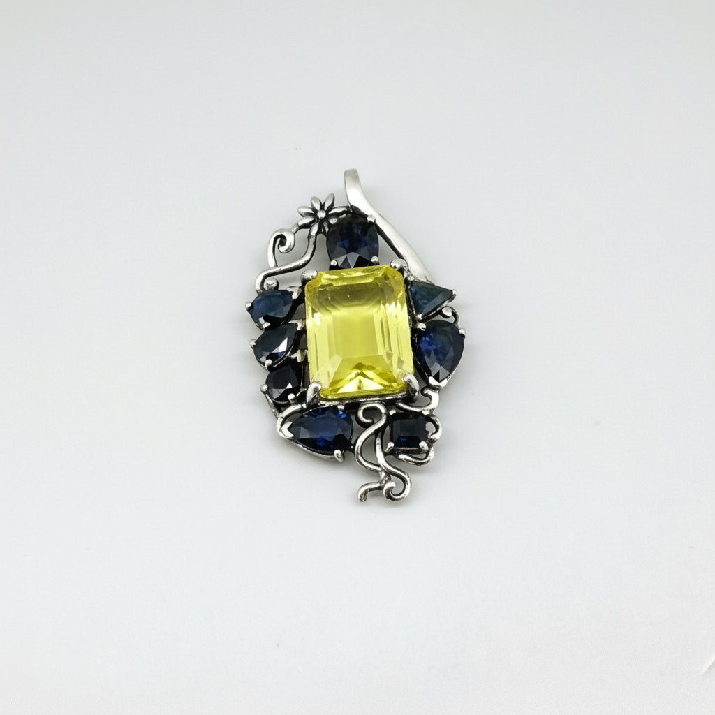 Handcrafted pendant with lemon quartz and blue sapphires set in white-gold-plated sterling silver.