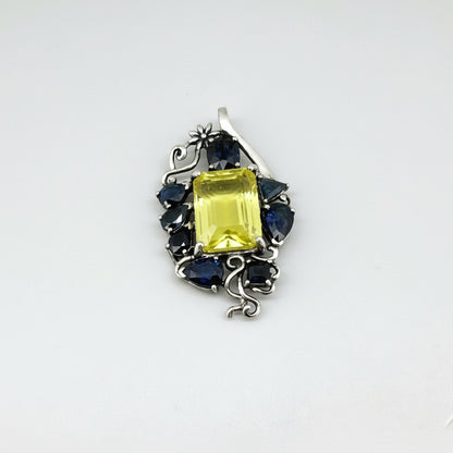 Handcrafted pendant with lemon quartz and blue sapphires set in white-gold-plated sterling silver.