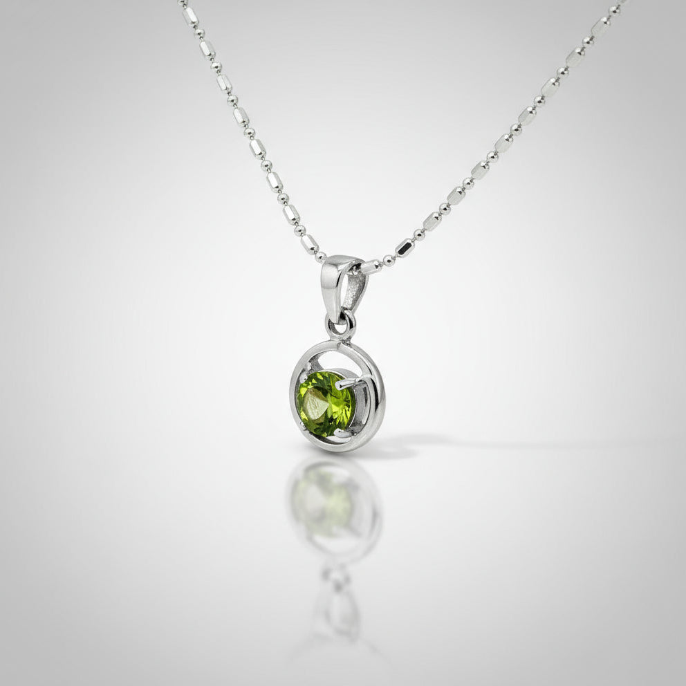 White-gold-plated silver pendant featuring a 1.36 ct natural peridot in a polished modern setting.
