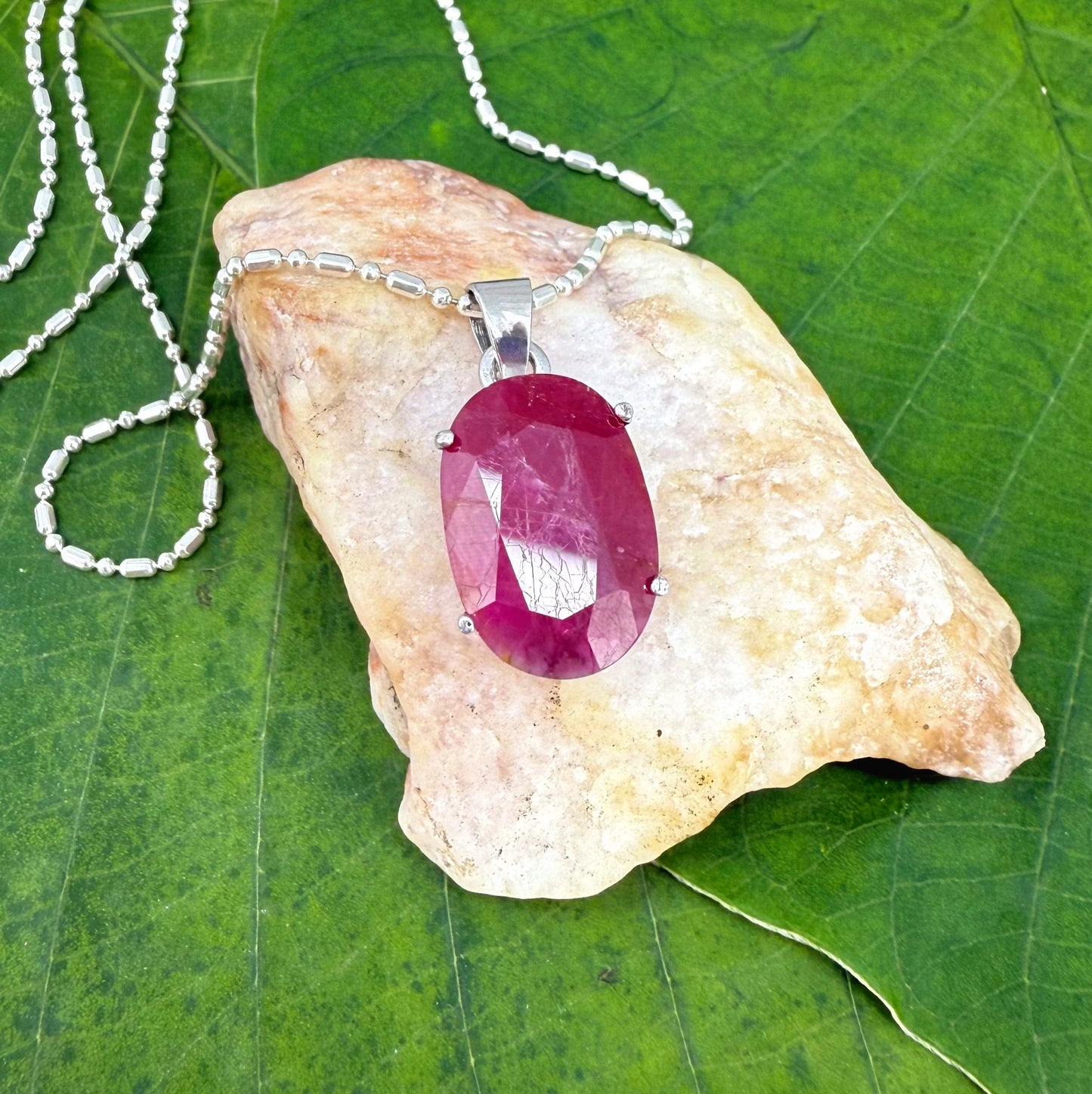 White gold plated silver pendant featuring a 17.12 ct natural ruby with deep red brilliance, handcrafted and elegant design.