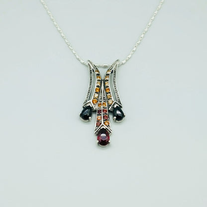 White Gold plated Silver Pendant with Garnets & Fancy Sapphires