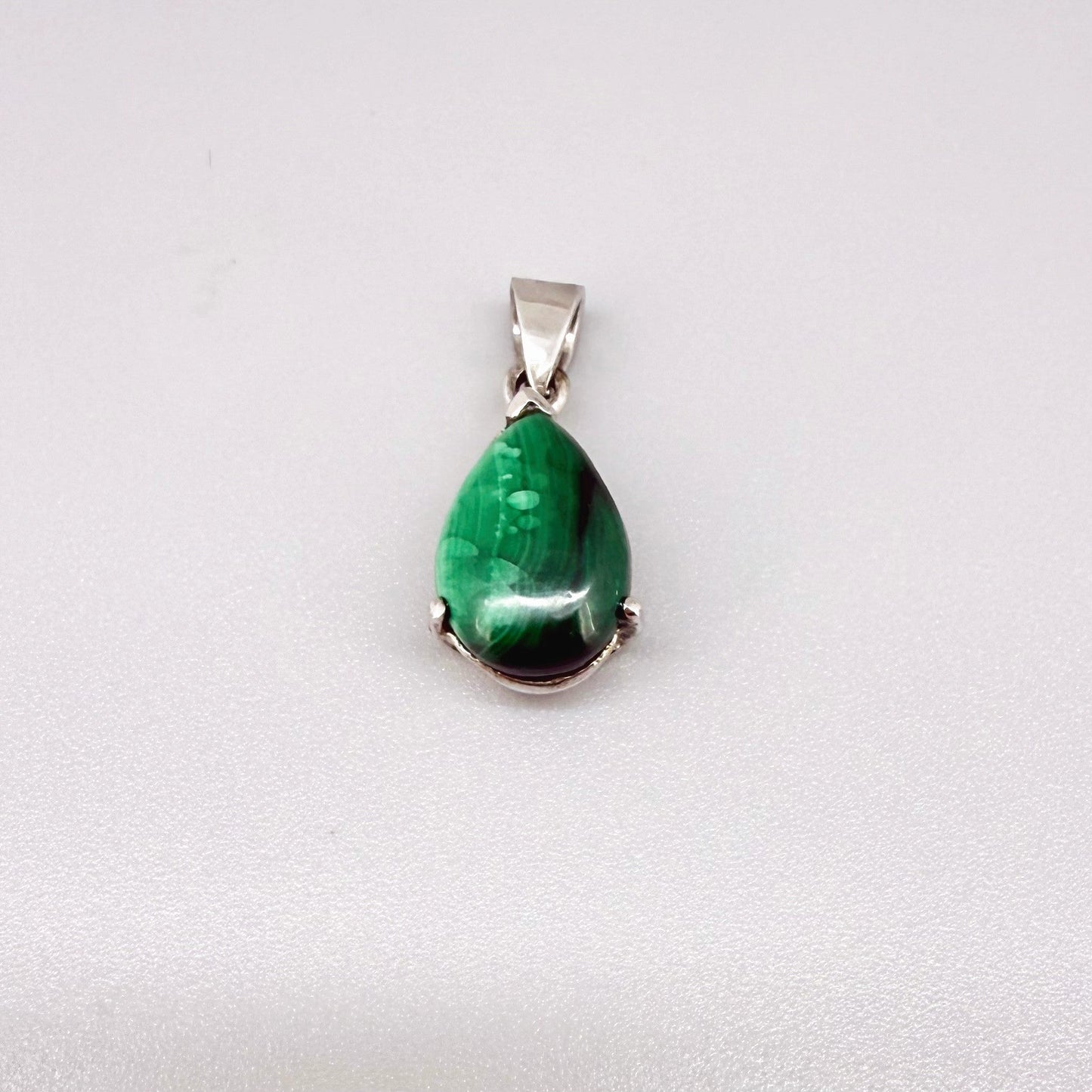 Sterling silver pendant featuring a 6.38 ct natural malachite with deep green banding.