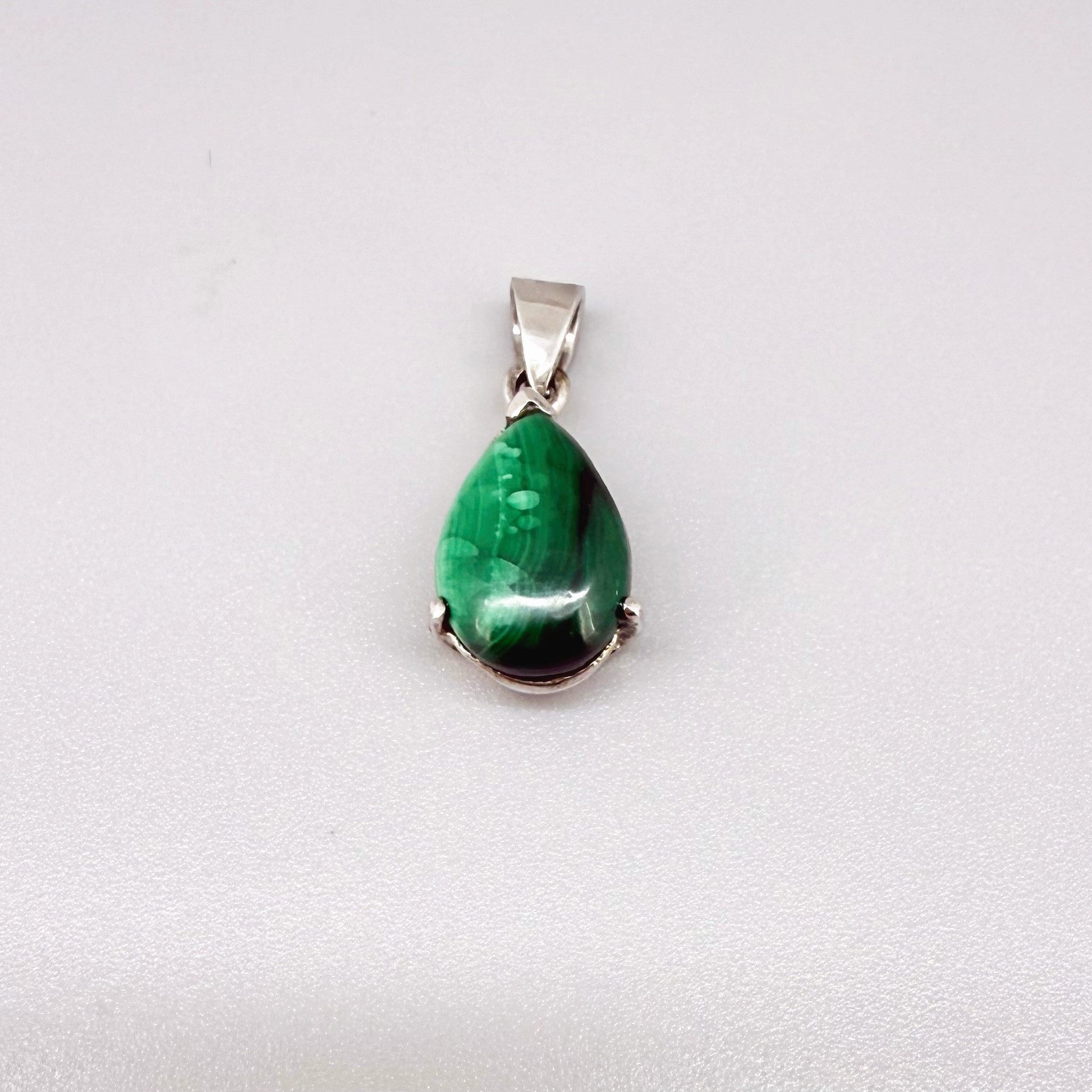 Sterling silver pendant featuring a 6.38 ct natural malachite with deep green banding.
