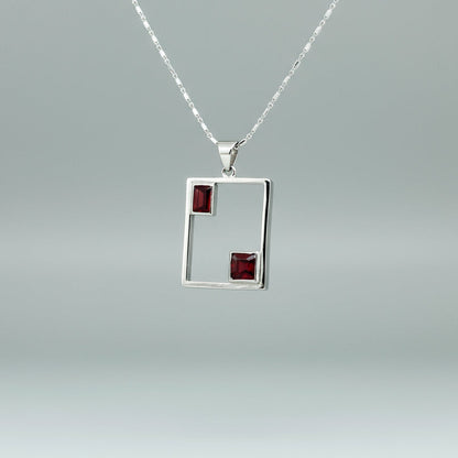 Modern handcrafted silver pendant with two natural rubies (3.24 ct total) set in an open square geometric frame.