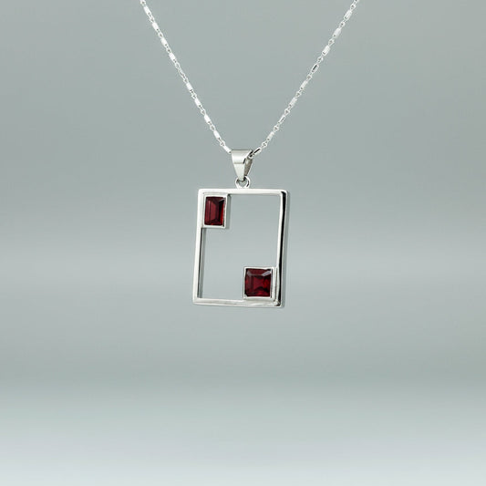Modern handcrafted silver pendant with two natural rubies (3.24 ct total) set in an open square geometric frame.