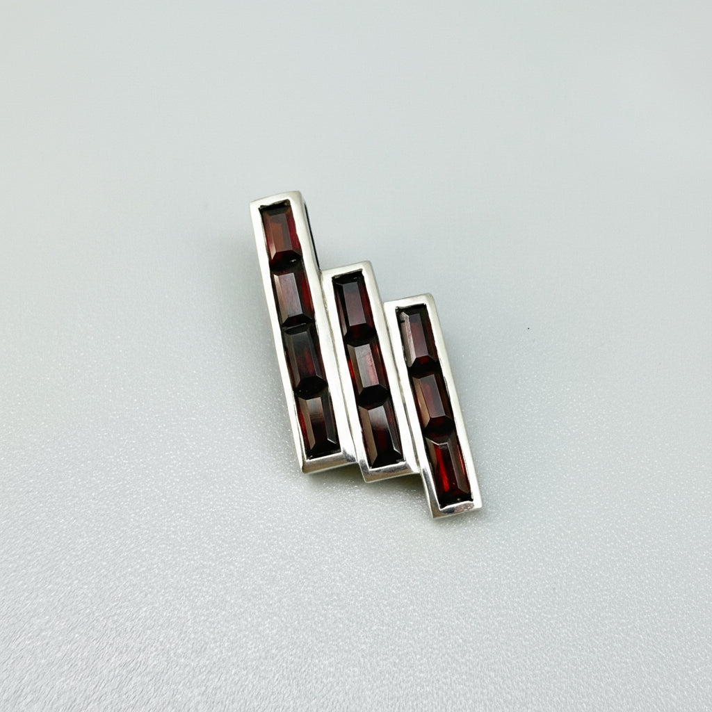 Handcrafted geometric pendant with 2.67 ct natural garnets set in sterling silver.