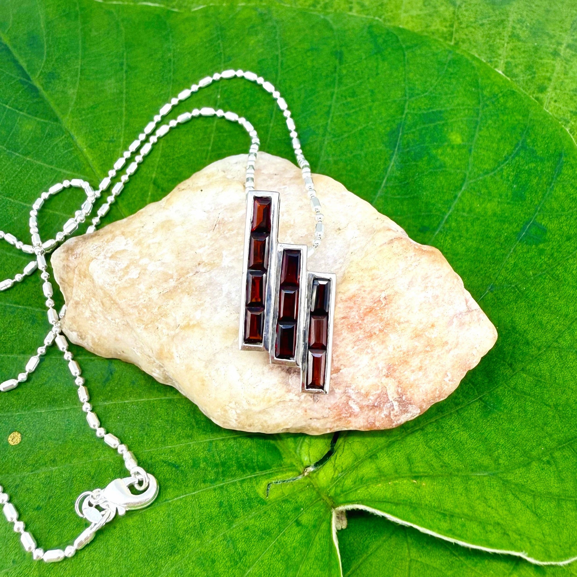 Handcrafted geometric pendant with 2.67 ct natural garnets set in sterling silver.
