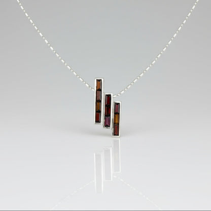 Handcrafted geometric pendant with 2.67 ct natural garnets set in sterling silver.