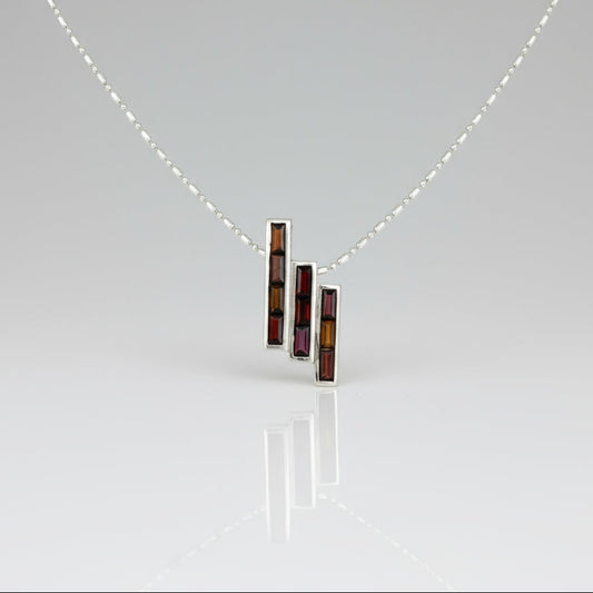 Handcrafted geometric pendant with 2.67 ct natural garnets set in sterling silver.