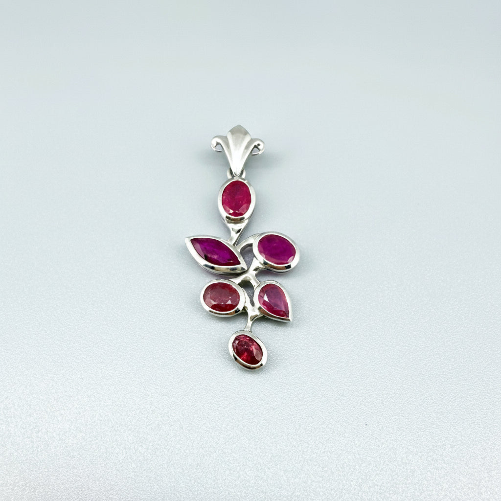 Handcrafted white-gold-plated silver pendant with 4.44 ct natural rubies in a floral design.