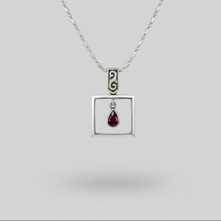 Handcrafted modern silver pendant with free-hanging teardrop ruby (0.55 ct) inside a square frame.