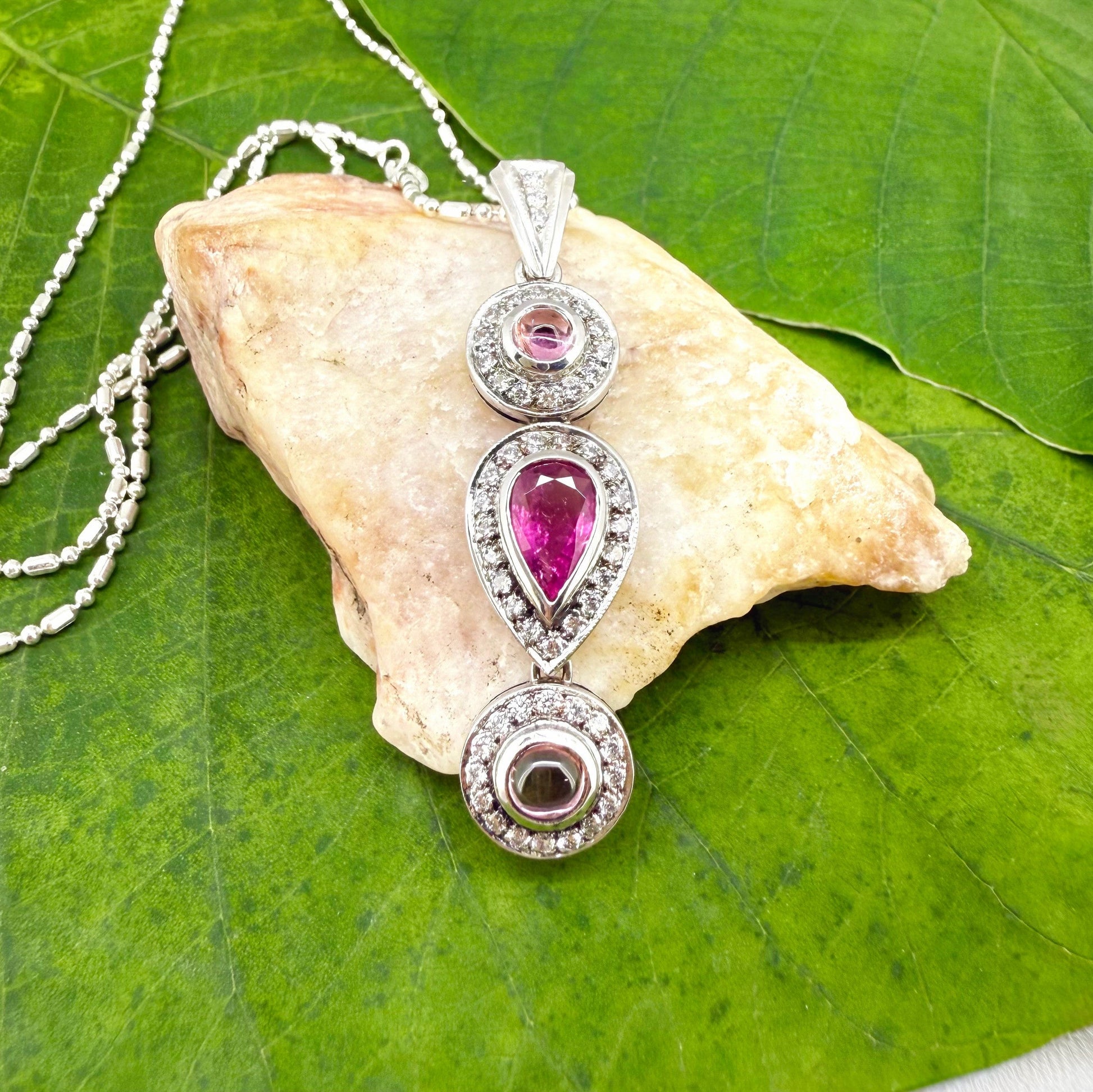 Handmade pendant featuring a 2.12 ct natural green tourmaline with cubic zirconia accents, set in white-gold-plated sterling silver.