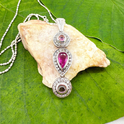 Handmade pendant featuring a 2.12 ct natural green tourmaline with cubic zirconia accents, set in white-gold-plated sterling silver.