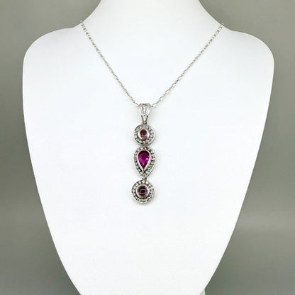 Handmade pendant featuring a 2.12 ct natural green tourmaline with cubic zirconia accents, set in white-gold-plated sterling silver.