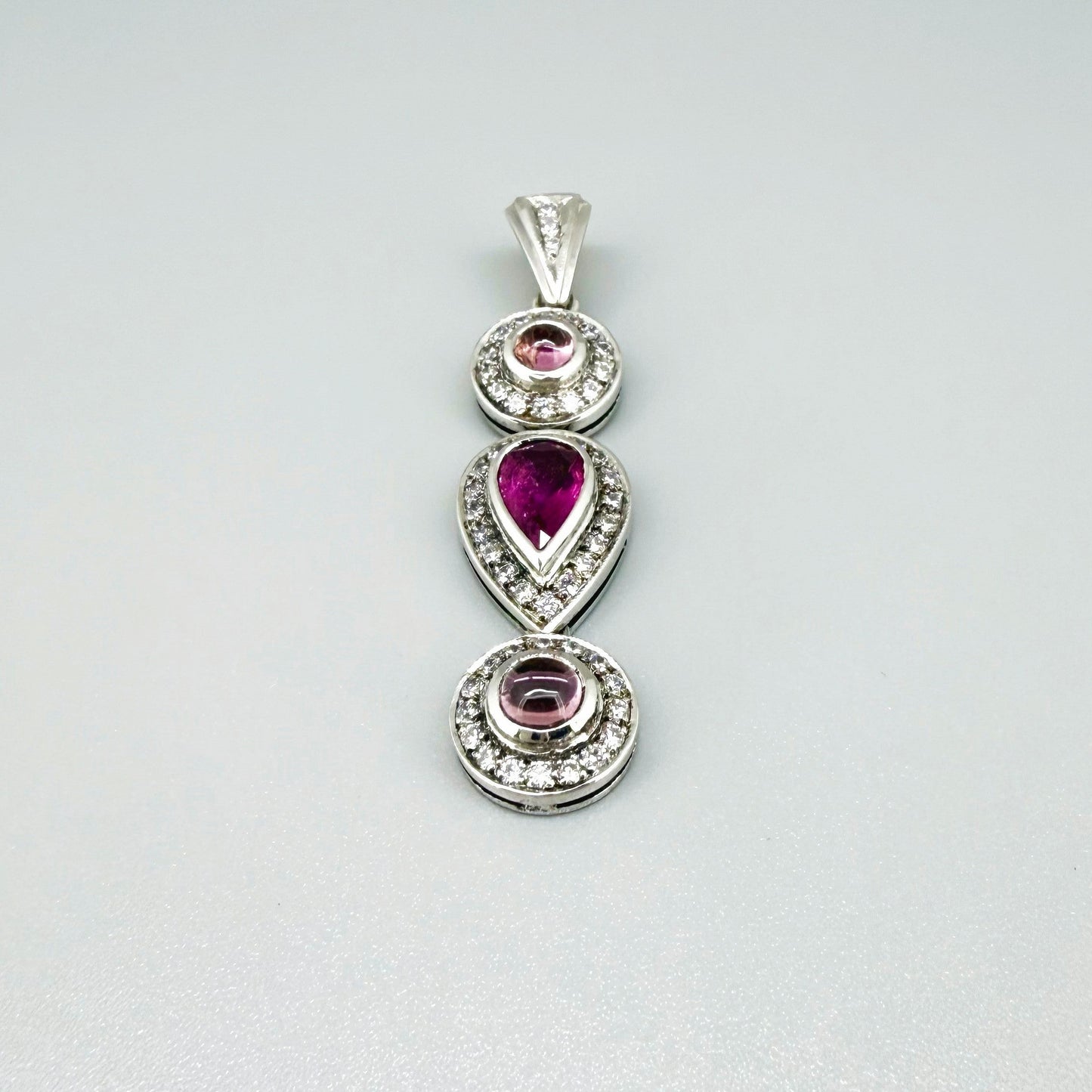 Handmade pendant featuring a 2.12 ct natural green tourmaline with cubic zirconia accents, set in white-gold-plated sterling silver.