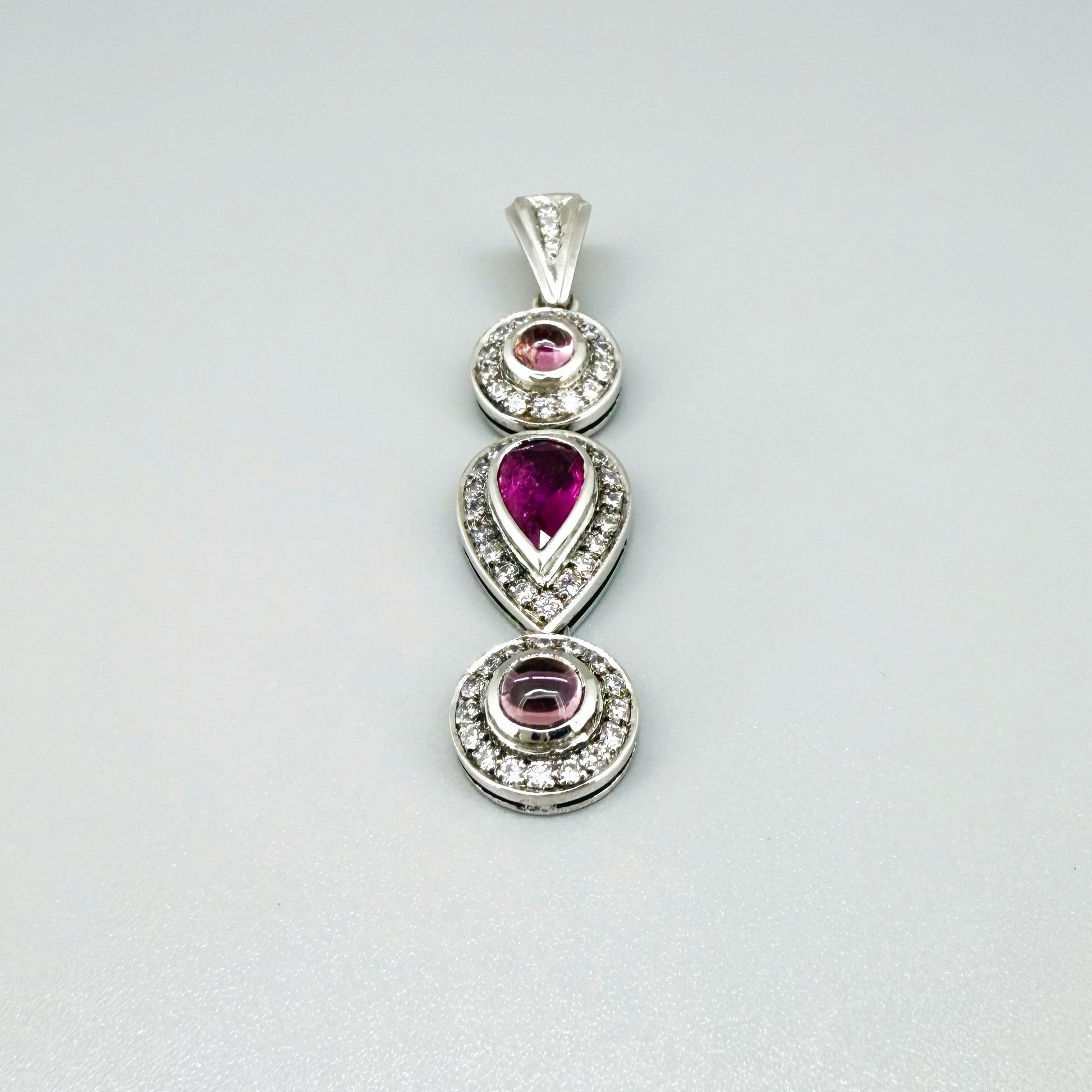 Handmade pendant featuring a 2.12 ct natural green tourmaline with cubic zirconia accents, set in white-gold-plated sterling silver.