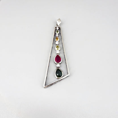 Handmade white gold plated silver pendant featuring 1.97 ct sapphires and 1.32 ct rubies in a modern geometric design with a freely moving gemstone strand.