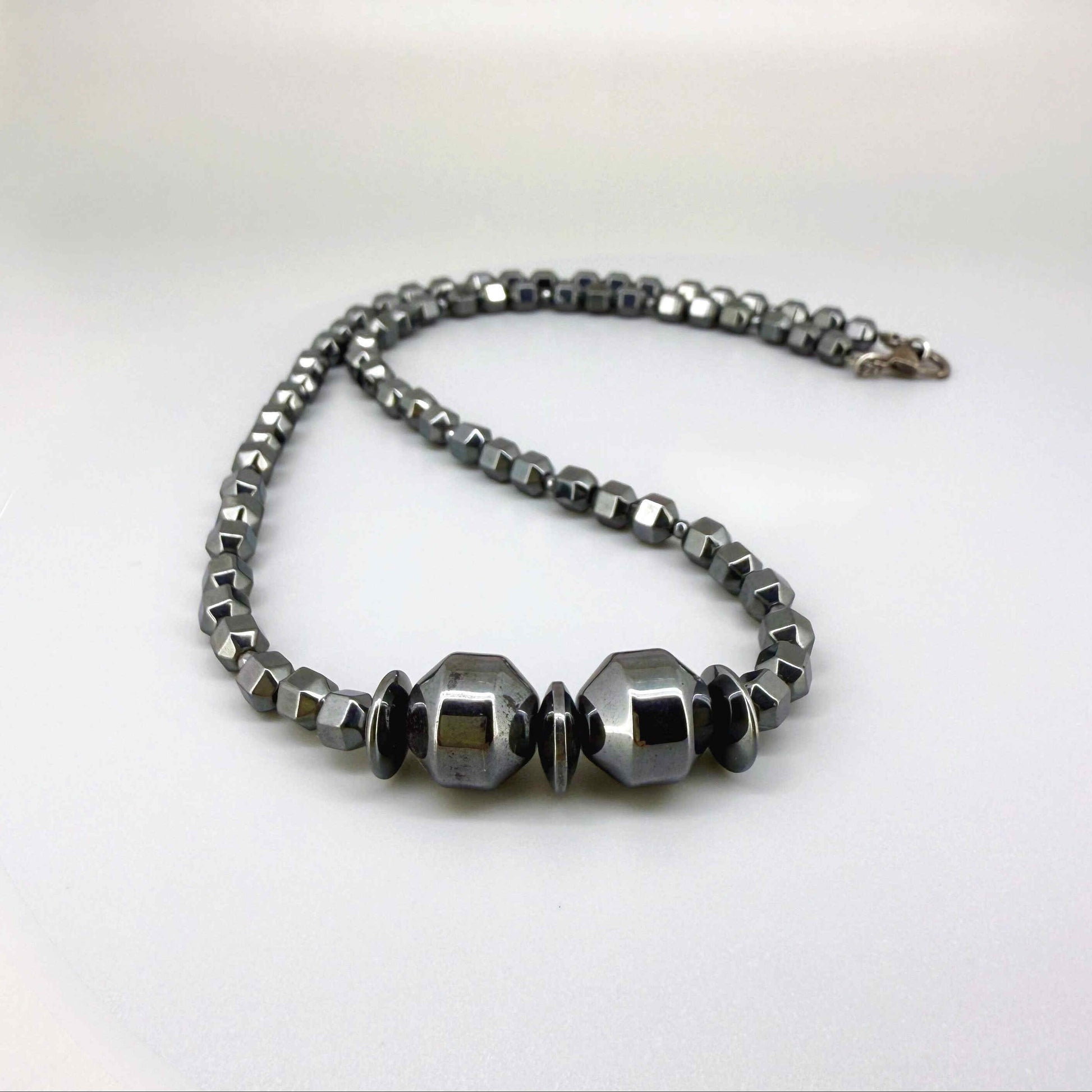 Hematite beaded necklace, 45 cm / 17.7 in long, with polished metallic grey stones and larger statement center beads.