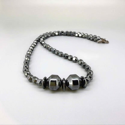 Hematite beaded necklace, 45 cm / 17.7 in long, with polished metallic grey stones and larger statement center beads.